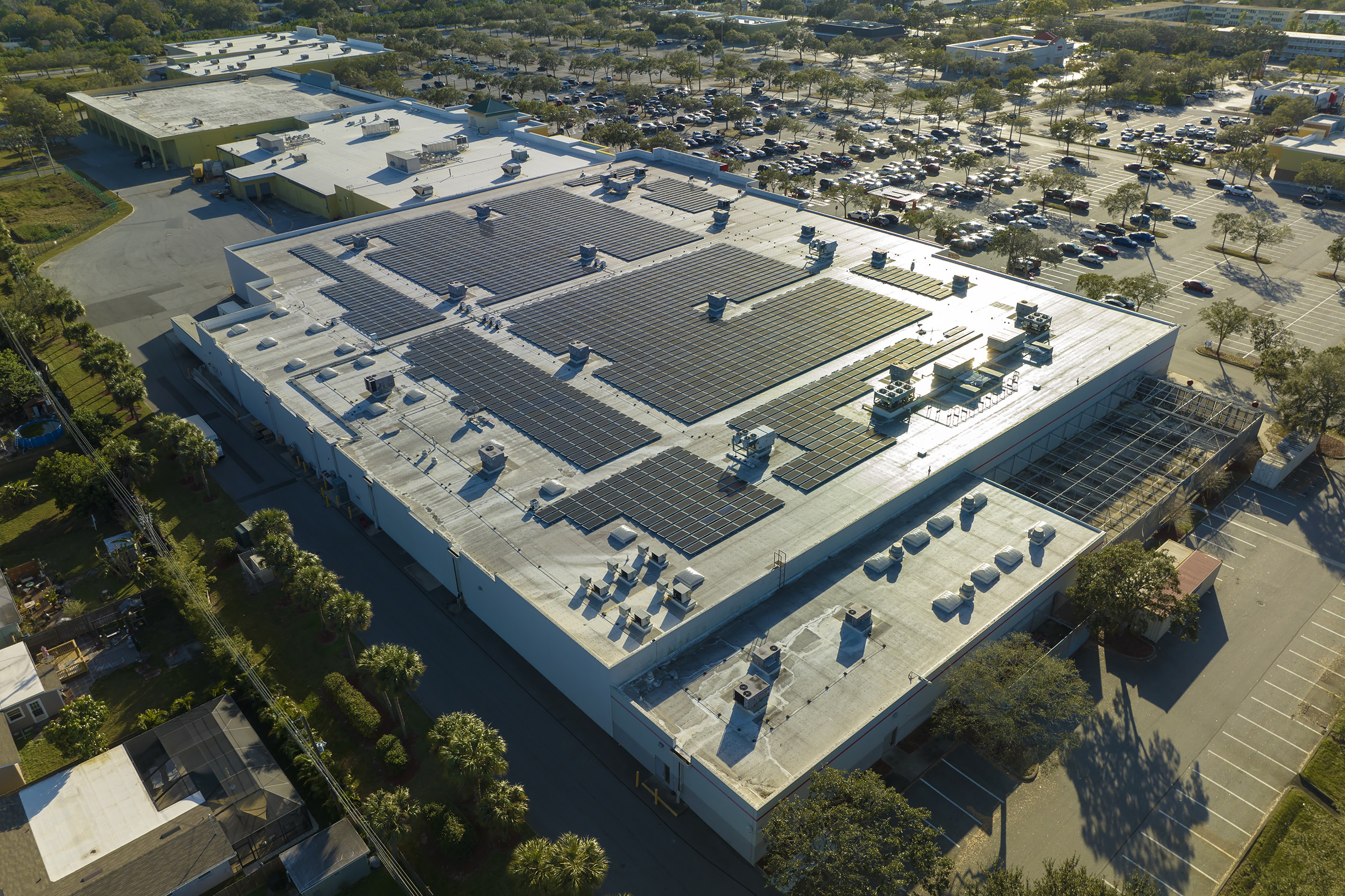 Venture capital Electric photovoltaic solar panels installed on shopping mall building rooftop for production of green ecological electricity. Concept of producing sustainable energy.