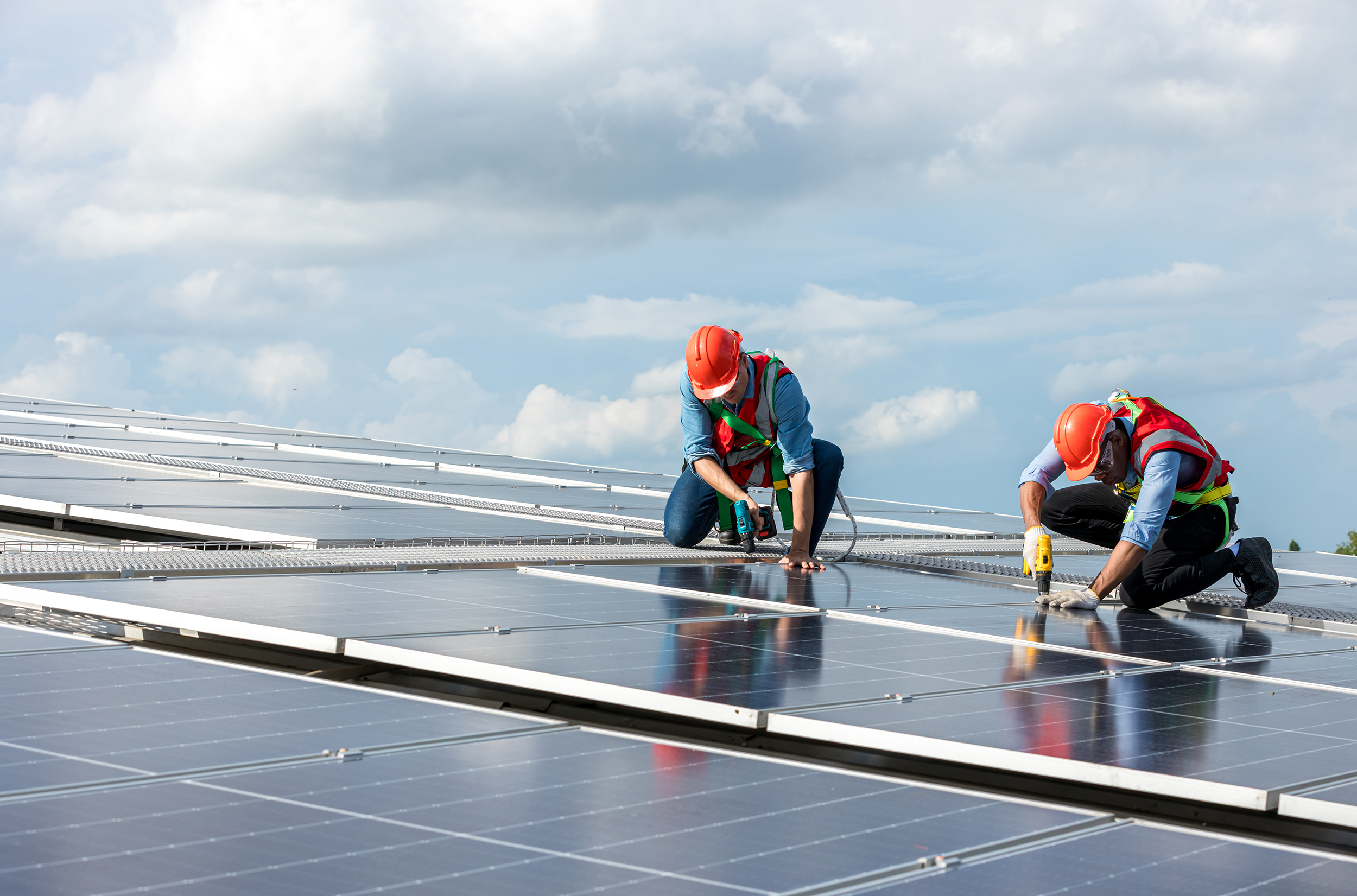 Venture capital Engineer working setup Solar panel at the roof top. Engineer or worker work on solar panels or solar cells on the roof of business building
